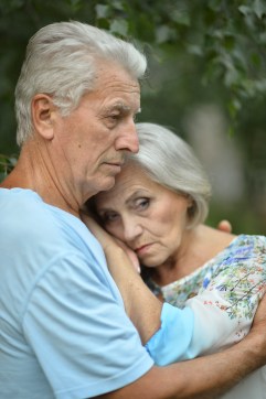 Sad senior couple in  park