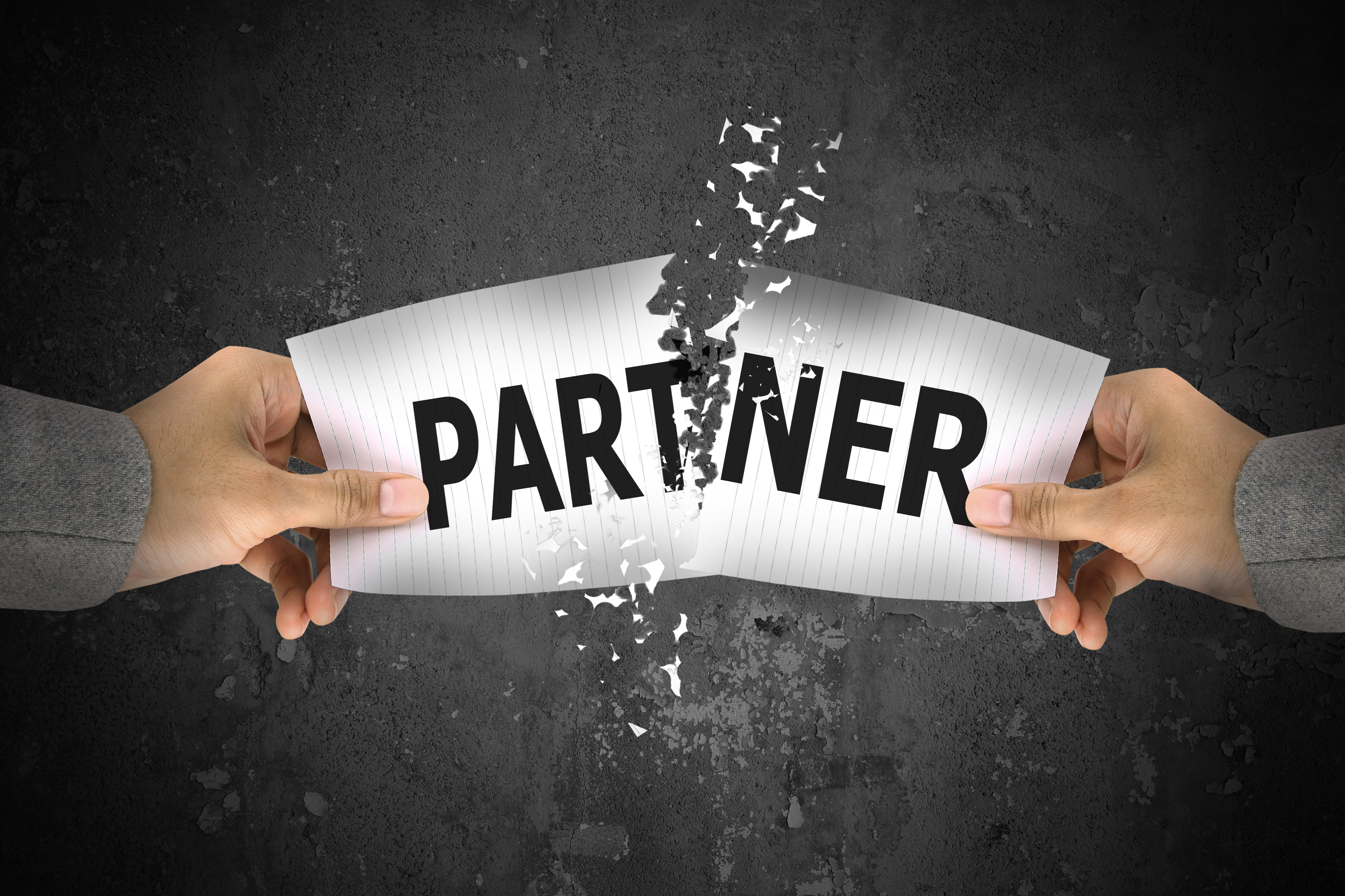 Businessman stress, ripping up partner word on paper